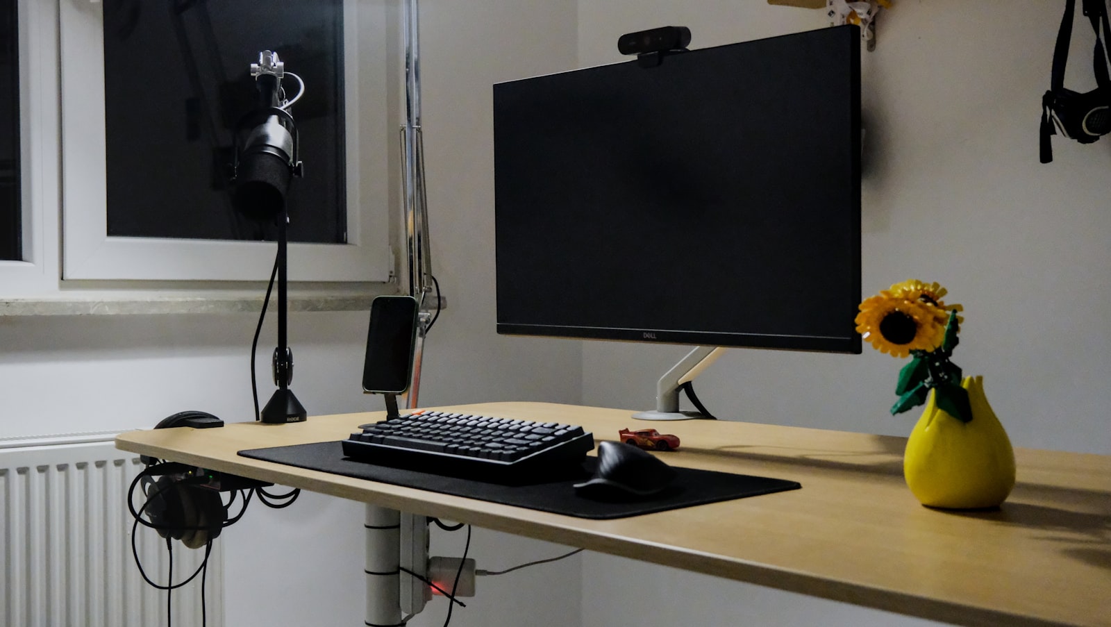 Home office desk setup with external webcam mounted on monitor